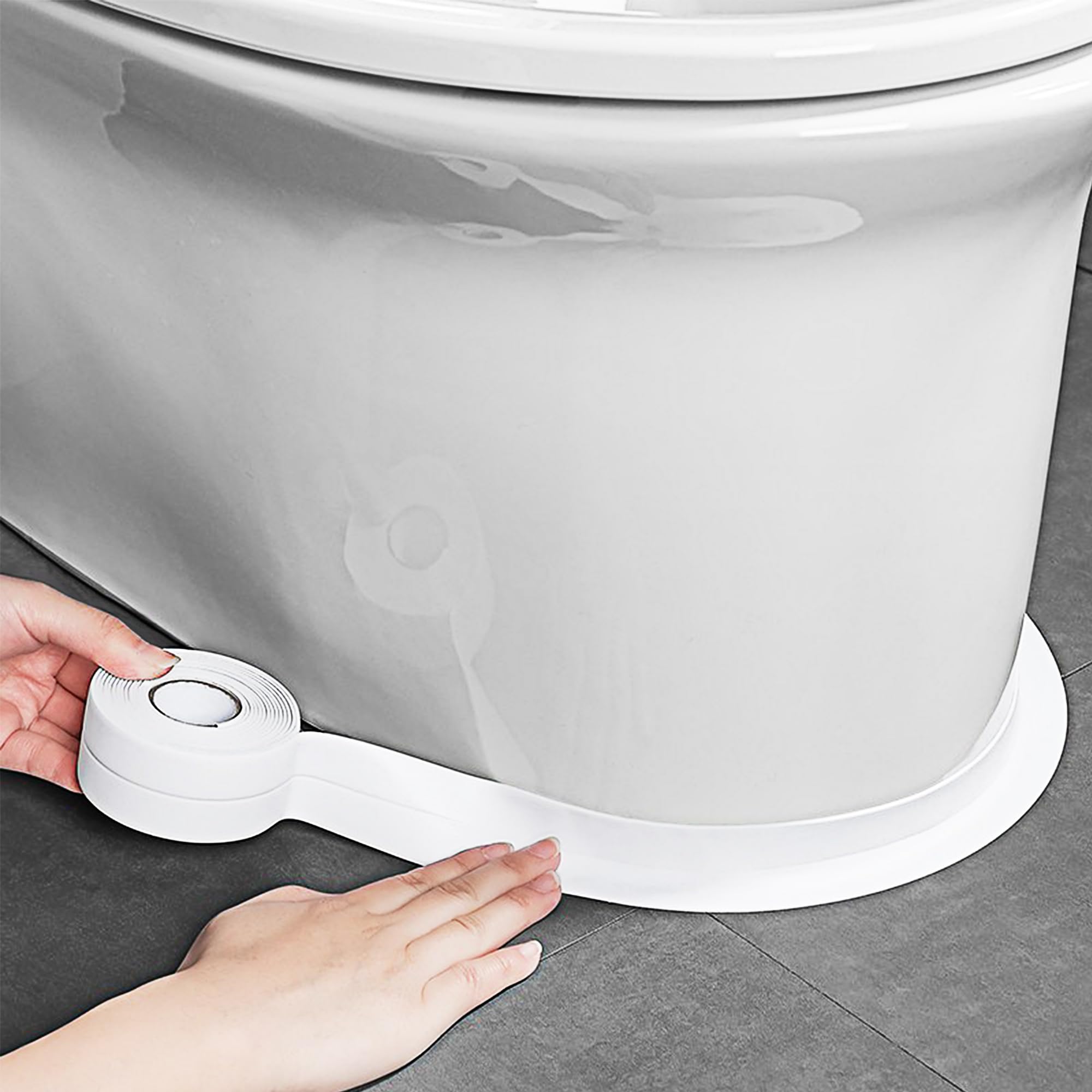 Applying caulk tape to toilet base