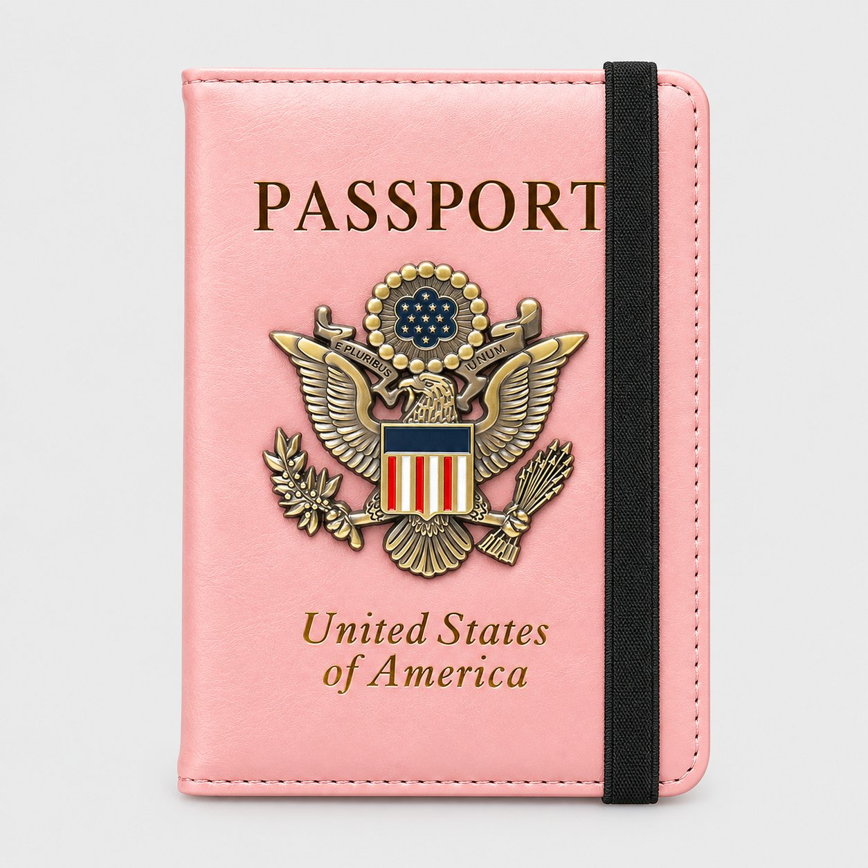 Pink passport holder with a gold-tone 3D metal eagle badge and black elastic closure