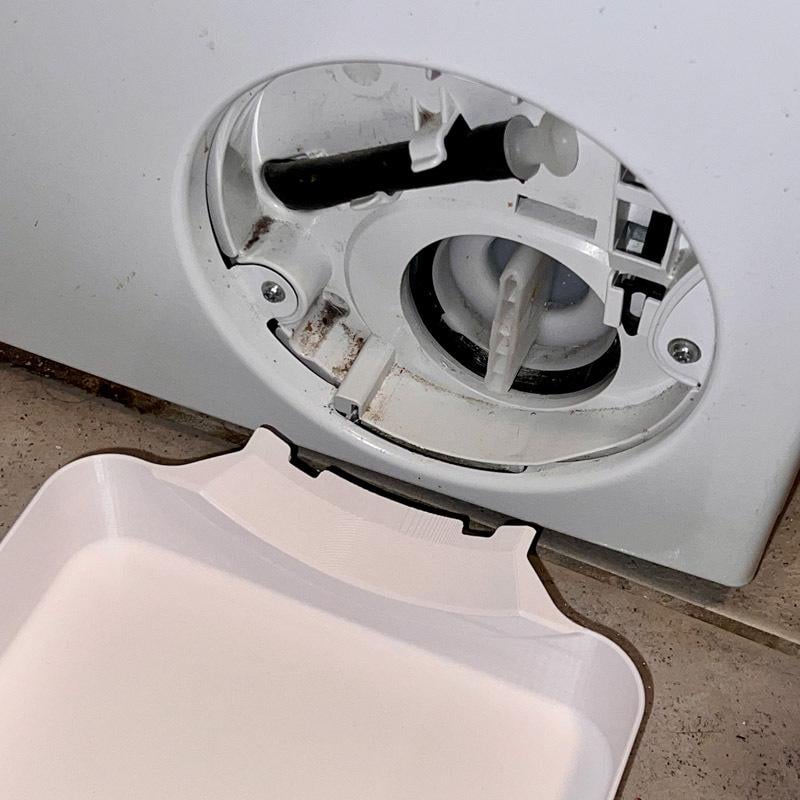 Emptying washer debris filter close up