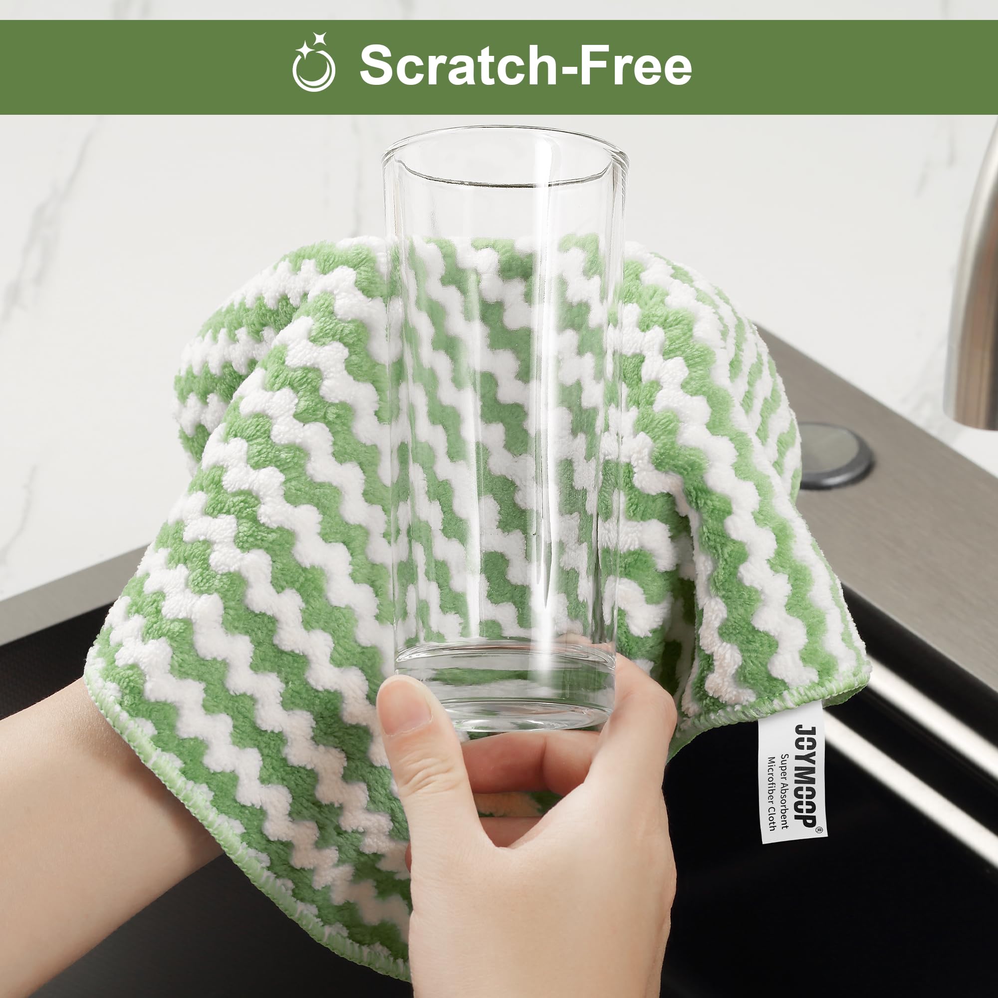 Wiping a delicate glass cup scratch free with green microfiber rag