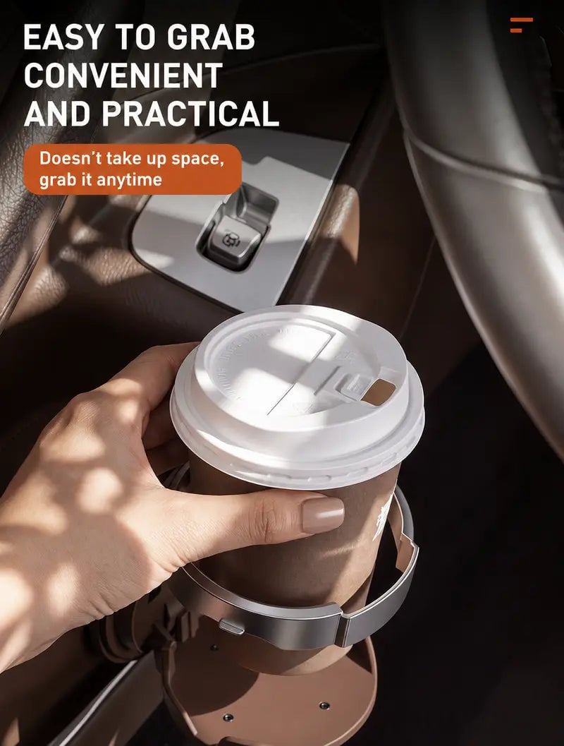 Hand lifting a lidded coffee cup from the foldable car cup holder